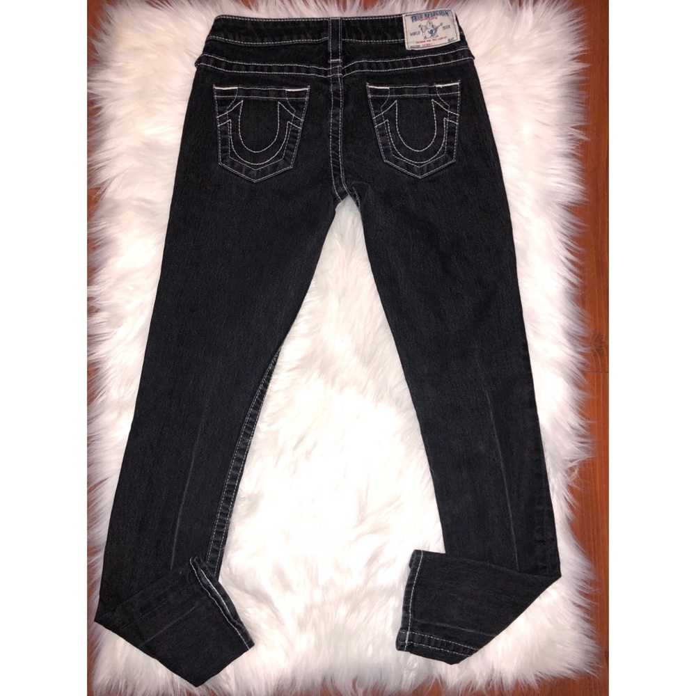 Black True Religion jeans with white stitching.